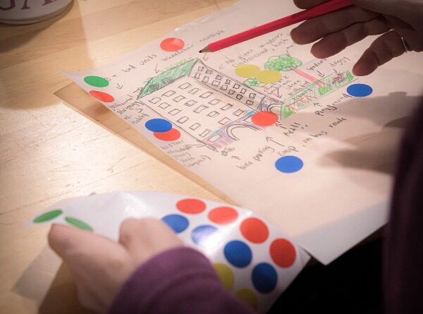 Workshop participant imagining how buildings in their neighbourhood could work better for their daily life and resilience.